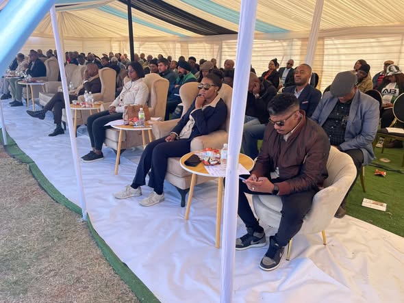 Guests seated under a tent at the HatsheLentle funeral scheme launch